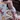 Baby in a diaper next to a box of diapers